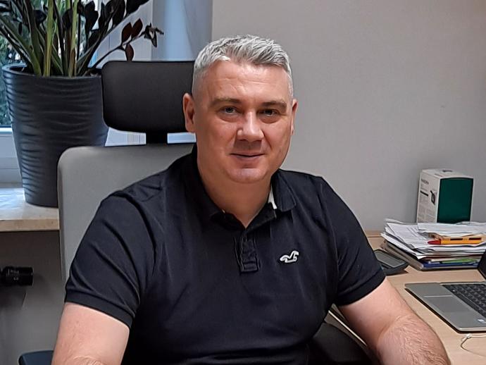 man smiling at desk