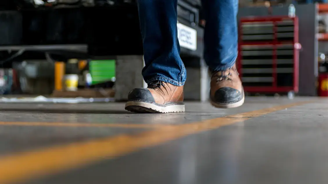 Man in safety boots walking a line